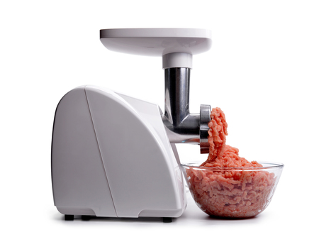 Electric meat grinder and bowl with minced meat isolated on a white background.の写真素材