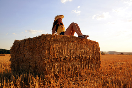 Girl on a balloon in the field at sunset.の写真素材