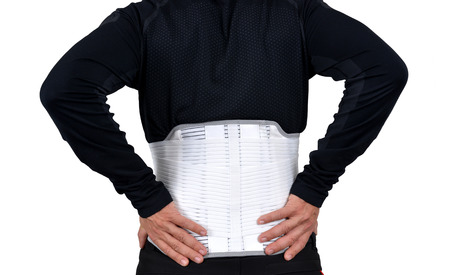 Man wearing back support belt isolated on white.