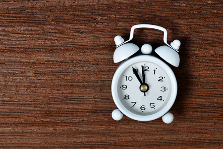White alarm clock on white background.