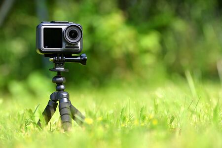 CHLUMCANY, CZECH REPUBLIC - JUNE 09, 2019: DJI Osmo Action in a tripod in grass.のeditorial素材