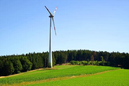 Wind turbine on meadow in summer rural landscape. Concept of clean energy. |の写真素材