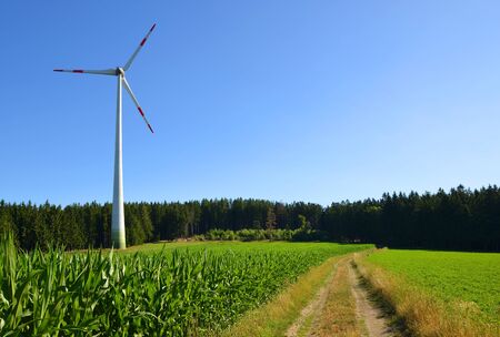 Wind turbine on meadow in summer rural landscape. Concept of clean energy. |の写真素材