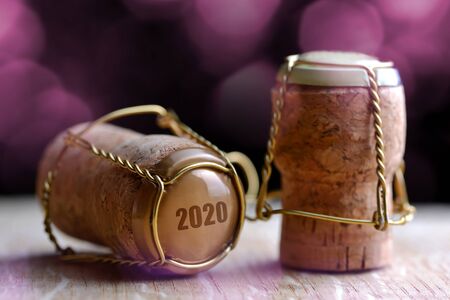 Cork stoppers of champagne on wooden board. Happy New Year concept.