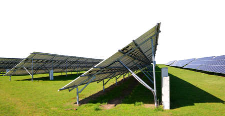 Solar energy panels on the meadow. Sustainable resources. Photovoltaic power station on white background.の写真素材