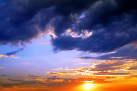 Dramatic colorful sky with clouds at sunset. Nature background.の写真素材