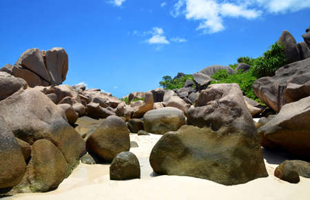 Anse Marron beach with big granite boulders on La Digue Island, Seychelles. Tropical landscape with sunny sky. Exotic travel destination.の写真素材