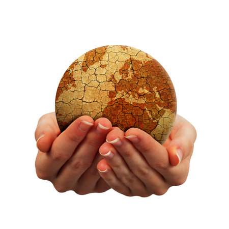 Parched planet earth in hands isolated on a white background. Global warming or change climate concept. Environmental problems.の写真素材