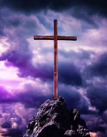 Christian wooden cross with stormy sky. Religion theme.の写真素材