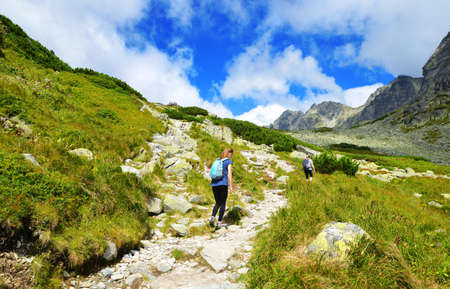 Hikers on trip in Mengusovska Valley, Vysoke Tatry (High Tatras), Slovakia. Mountain landscape in the Western Carpathians.の写真素材