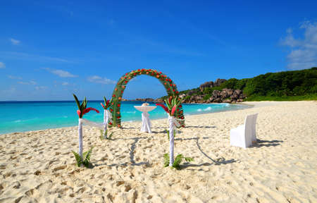 LA DIGUE, SEYCHELLES - MARCH 16, 2020: Beach wedding arch ceremonial decorated with flowers, Grande Anse, La Digue Island, Indian Ocean, Seychelles. Tropical destination.のeditorial素材