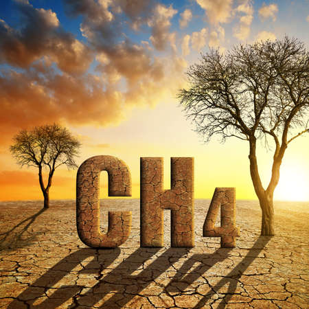 Parched landscape with dry trees and CH4 text at sunset. Global warming or change climate concept. Environmental problems. Growing methane in the atmosphere.の写真素材