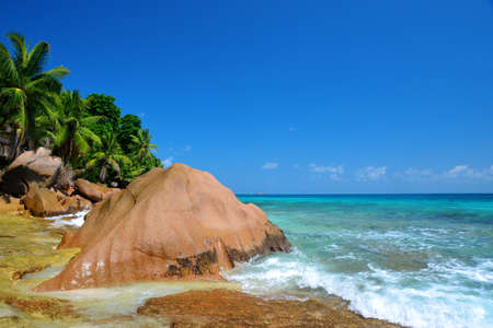 Large granite boulders in Anse Patates beach, La Digue Island, Indian ocean, Seychelles. Beautiful tropical landscape with sunny sky. Exotic travel destinations.の写真素材