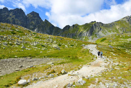Hikers on trip in Mengusovska Valley, Vysoke Tatry (High Tatras), Slovakia. Mountain landscape in the Western Carpathians.の写真素材