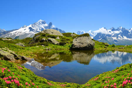 Mountain landscape reflected on the surface of the lake. Nature Reserve Aiguilles Rouges, French Alps, France, Europe.の写真素材