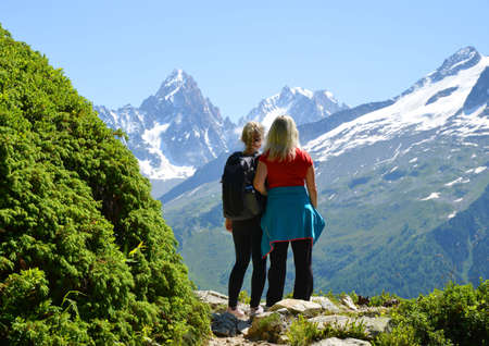 Hikers looking at the Mount Blanc massif. French Alps, Chamonix, France.の写真素材