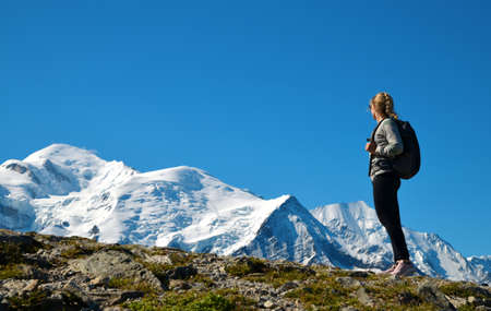 Hiker looking at the Mount Blanc from the summit of Le Brevent. French Alps, Chamonix, France.の写真素材