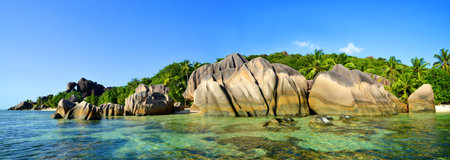 Panoramic view of a beautiful beach Anse Source d'Argent with big granite rocks in sunny day. La Digue Island, Indian ocean, Seychelles. Tropical landscape.の写真素材
