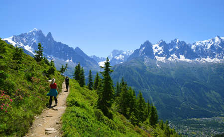 Idyllic landscape with Mont Blanc mountain range in sunny day. Hikers on trip in the Nature Reserve Aiguilles Rouges, French Alps, France, Europe.の写真素材