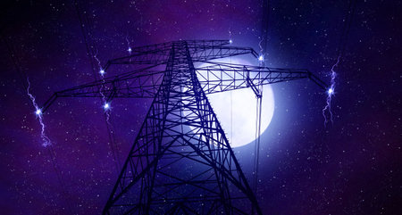 Electric pylon. Transmission tower with night sky with full moon in the background.の写真素材