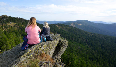 Two female tourists on the top of the mountain Klein Osser in the National park Bayerischer Wald, Germany.の写真素材