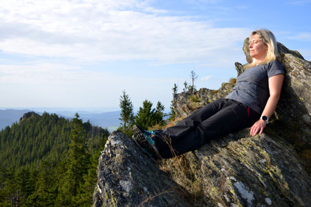 Woman on top of mountain Grosser Osser ( Velky Ostry ) in the National park Bayerischer Wald, Germany.の写真素材