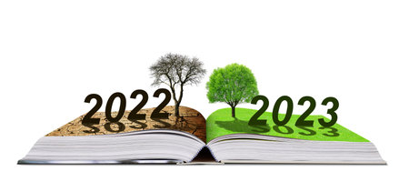 Open book with numbers 2022 and 2023 isolated on a white background. Concept of Happy New Year. Global warming or climate change theme.の写真素材