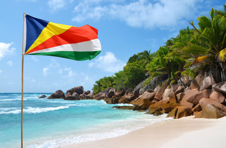Anse Cocos beach with flag of Seychelles in the La Digue Island, Indian Ocean. Tropical landscape with sunny sky. Exotic travel destination.の写真素材