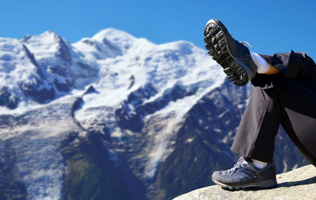 Hiker resting in the Graian Alps. Mont Blanc mountain range, Nature Reserve Aiguilles Rouges, France.の写真素材