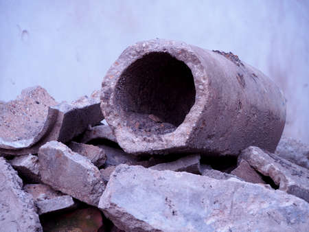 gray broken concrete pipes, remnants of sewer repair, old concrete pipe, construction waste,...