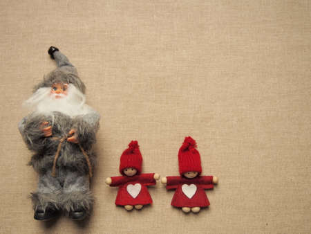 christmas  gray santa claus with glasses and two little red elfs with white heart on dress and...