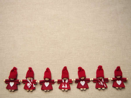 christmas card, seven little red elfs with white heart on dress and knitted hat on gray background, winter background wallpaperの写真素材