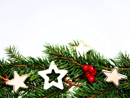 christmas decoration background for greeting card, spruce twigs with white decorative wooden stars...