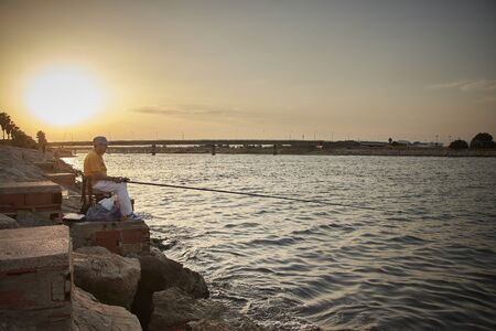 Some pictures of a some fishermen front a mediterranean seaの写真素材