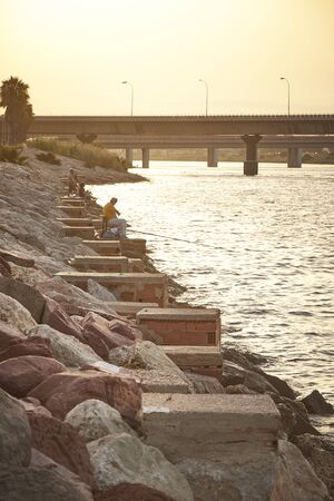 Some pictures of a some fishermen front a mediterranean seaの写真素材