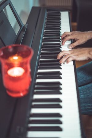 Pretty woman play the piano in home at confined daysの写真素材