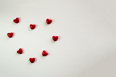 Valentine card with heart decor on a white table. Top view with space for your greeting.の写真素材