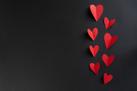 valentines day background, border red heart on black table, flat lay. The concept of Valentines Day.の写真素材
