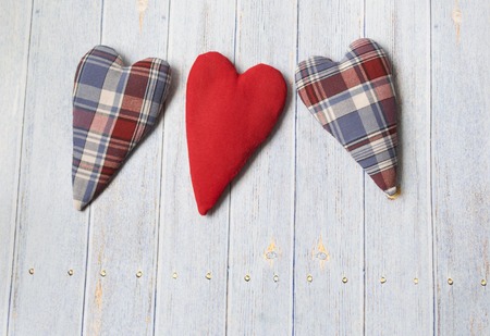 textile hearts in vintage style on a light wooden background. Place for text. Wedding concept, mother's day.の写真素材