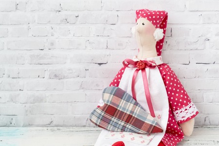 Textile doll-housewife. With handmade textile hearts. handmade doll girl tilda. Holidays decoration. Interior fairy dolls. Women friendship. Relations.の写真素材