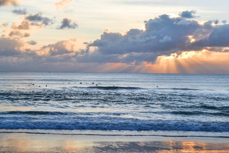 The sun sets over the sea, a beautiful sunset with clouds and waves in the sea. Sunset. Sunrise over waterの写真素材