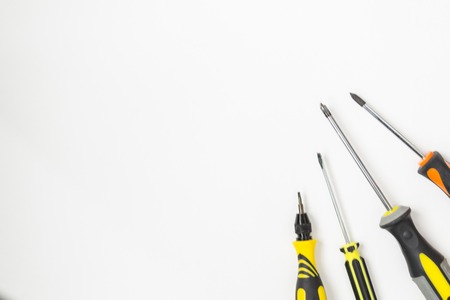 Repair tools top view on a white background. Screwdrivers, cutter, pencil, saw, pliers. There is a...