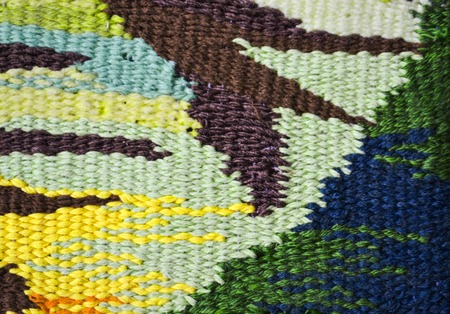 Colored grungy textured background or wallpaper from coarse woven multicolor and empty space....