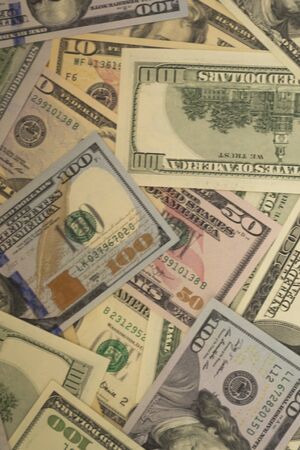 American money dollars are lying chaotically. Different denominations. Money background.の写真素材