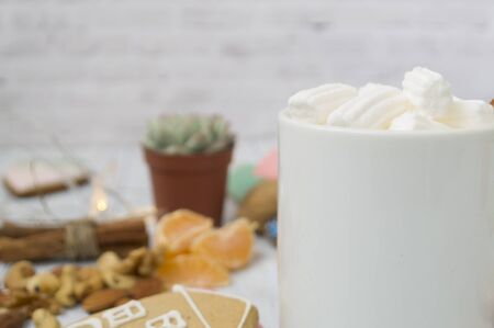 Hot cocoa drink for Christmas and winter holidays with gingerbread, nuts, festive decor On a wooden background.の写真素材