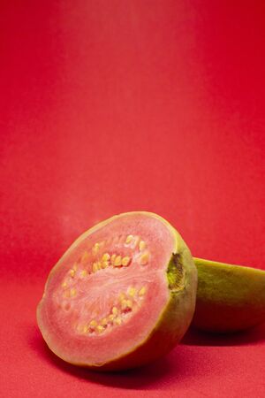 Pink guava cut in half on a pink background. Close-upの写真素材