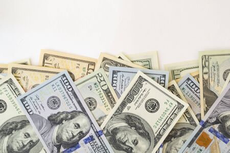 Side frame of different dollar cuperas randomly lie on a white background. Concept business, monetary fund. There is a place for text.の写真素材