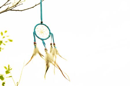 Dream catcher close-up on a white sky background. Blurred background. Copy spaceの写真素材