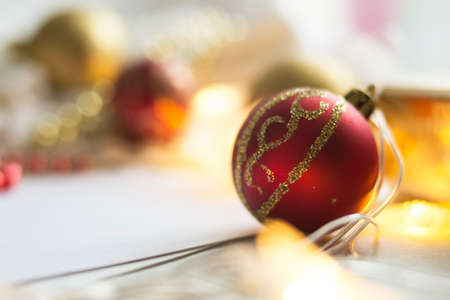 New Year red ball on abstract blurred background. Christmas concept. There is a place for text.
