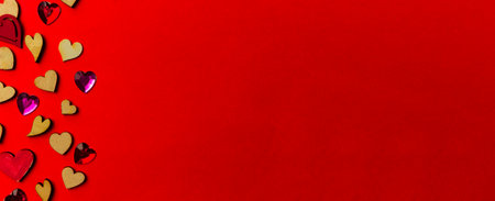 Valentine's day background from wooden and crystal hearts on a red backdrop. Saint valentine long banner. Love and wedding concept.の写真素材